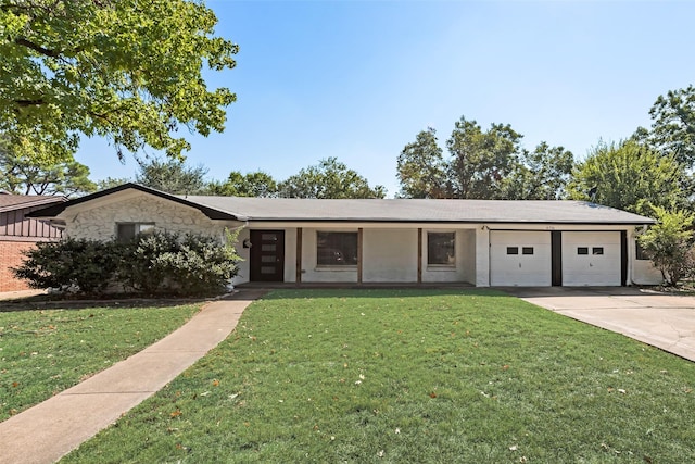 view of front of property with an attached garage, a front yard, concrete driveway, and stone siding