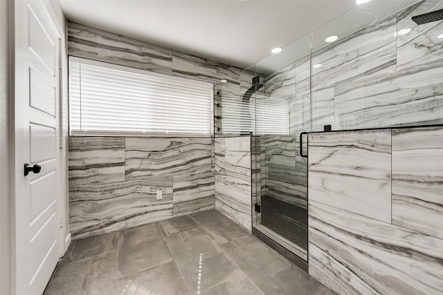 bathroom featuring a marble finish shower and recessed lighting