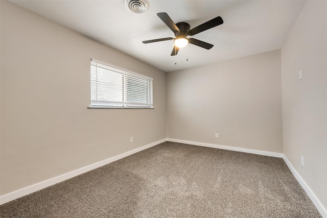 spare room with carpet flooring, baseboards, and ceiling fan