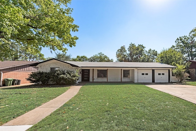 view of front of house featuring an attached garage, a front lawn, concrete driveway, and stone siding