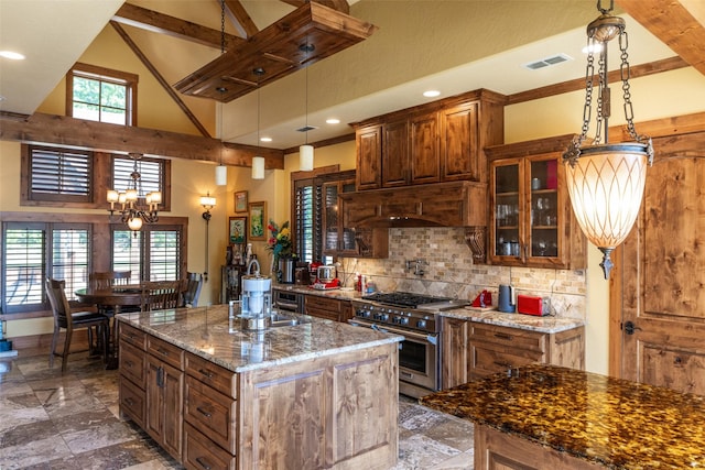 SQ13 Lake Cherokee, Henderson, TX 75652 - kitchen featuring stone countertops, high end stainless steel range, high vaulted ceiling, decorative backsplash, and an island with sink