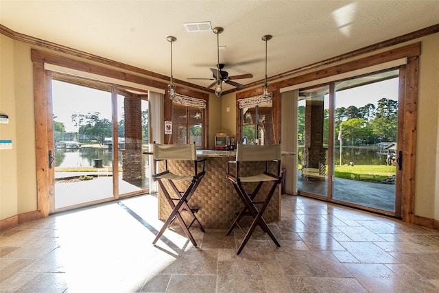 SQ13 Lake Cherokee, Henderson, TX 75652 - dining space with a water view, stone tile floors, visible vents, baseboards, and ceiling fan