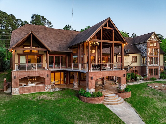 SQ13 Lake Cherokee, Henderson, TX 75652 - back of house with a balcony, a lawn, brick siding, a patio area, and a shingled roof