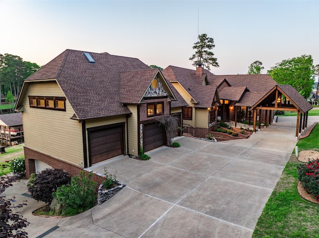 SQ13 Lake Cherokee, Henderson, TX 75652 - view of front facade with concrete driveway, a garage, a shingled roof, and brick siding