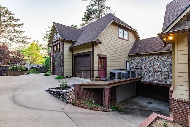 SQ13 Lake Cherokee, Henderson, TX 75652 - view of side of home with a balcony, driveway, cooling unit, a garage, and roof with shingles