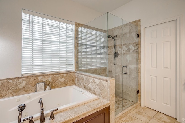 full bath featuring a tub with jets, tile patterned flooring, and a stall shower