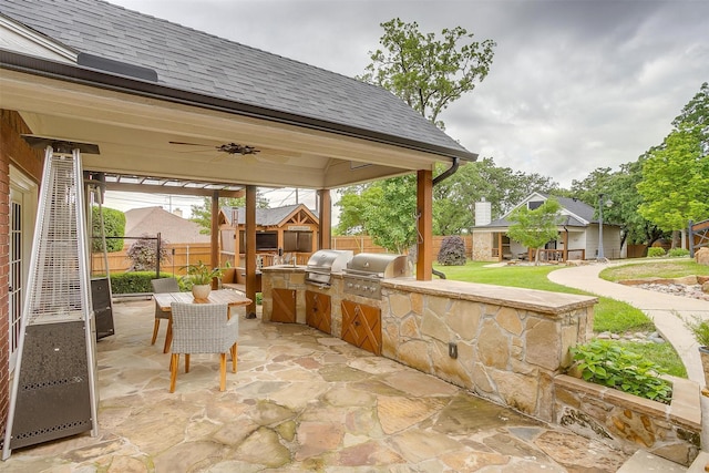 view of patio featuring grilling area, area for grilling, ceiling fan, and a fenced backyard