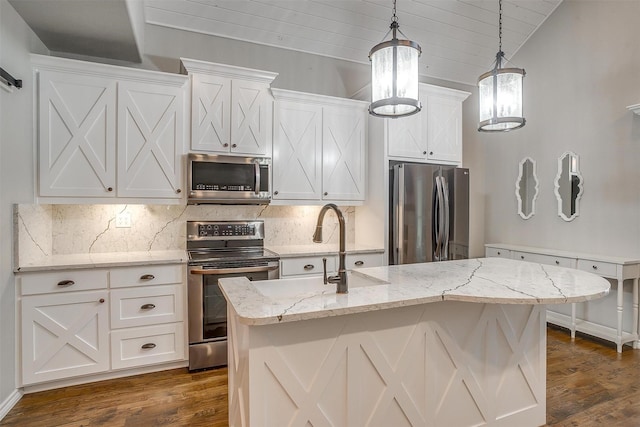 kitchen featuring decorative light fixtures, dark wood-style flooring, decorative backsplash, white cabinets, and appliances with stainless steel finishes