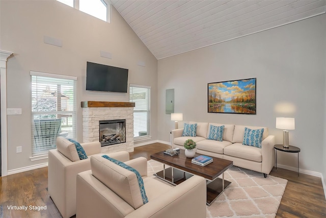 living room featuring baseboards, a wealth of natural light, high vaulted ceiling, wood finished floors, and a fireplace