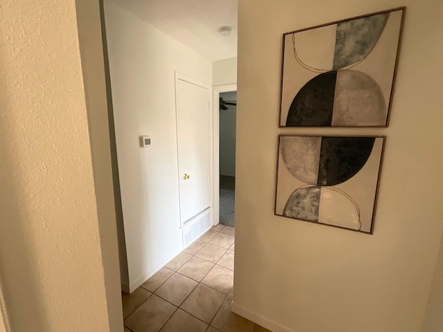 9434 Chimney Corner Ln, Dallas, TX 75243 - hallway featuring baseboards, visible vents, and tile patterned floors