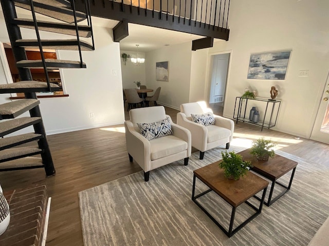 9434 Chimney Corner Ln, Dallas, TX 75243 - living room with wood finished floors, a towering ceiling, stairway, a chandelier, and baseboards