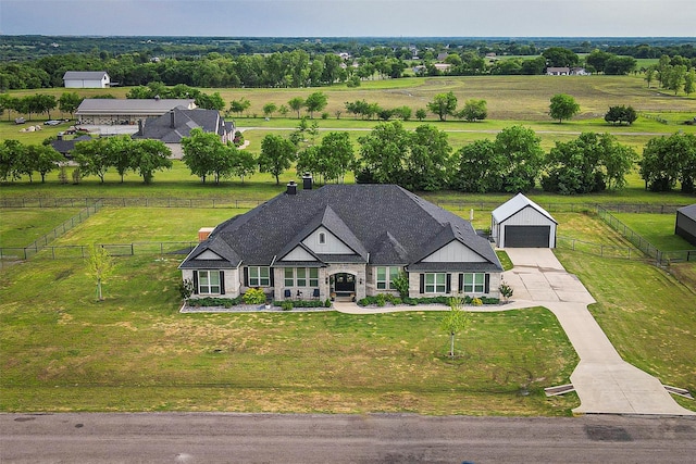 birds eye view of property with a rural view
