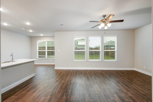 627 Rain Barrel Pl, Weston, TX 75009 - unfurnished living room featuring a sink, ceiling fan, a wealth of natural light, dark wood-style floors, and baseboards