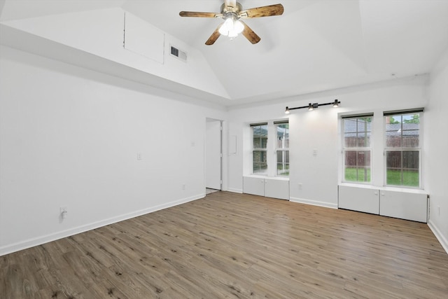 unfurnished room with a ceiling fan, visible vents, plenty of natural light, and wood finished floors