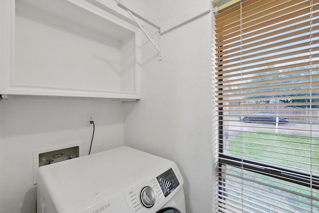 clothes washing area featuring washer / dryer