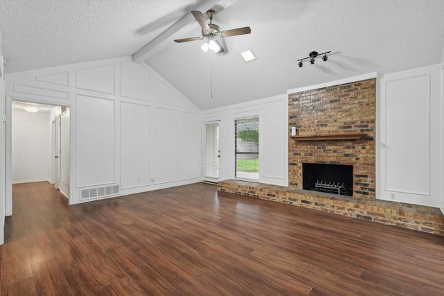 unfurnished living room with a textured ceiling, a ceiling fan, visible vents, and dark wood finished floors