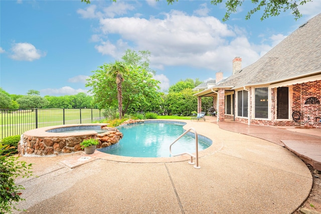 view of swimming pool with an in ground hot tub, a patio area, a fenced in pool, and fence
