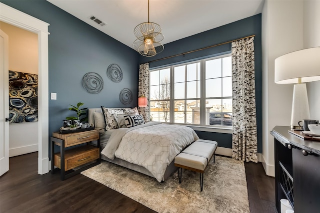 1725 Ranch House Rd, Celina, TX 75009 - bedroom with dark wood-type flooring, baseboards, and a chandelier