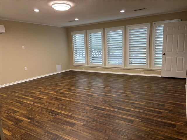 unfurnished room with ornamental molding, visible vents, recessed lighting, dark wood finished floors, and baseboards