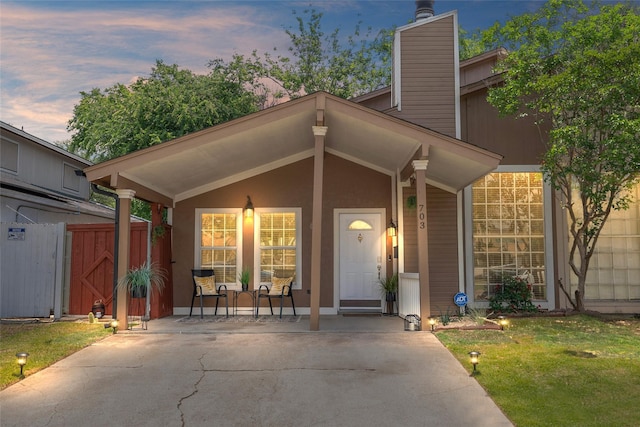 703 Trinidad Dr, Grand Prairie, TX 75052 - mid-century modern home with a chimney, a front lawn, and a gate