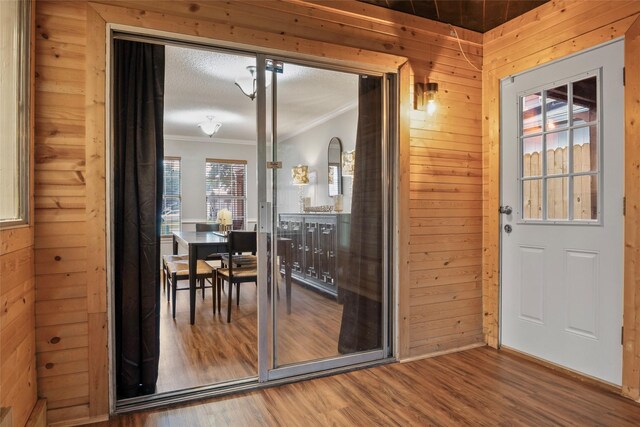 703 Trinidad Dr, Grand Prairie, TX 75052 - doorway to outside with wood walls, wood finished floors, and crown molding