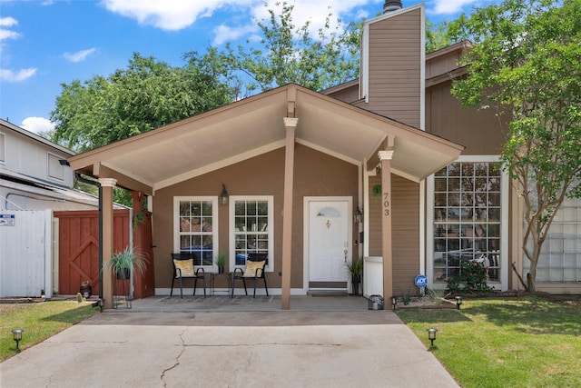703 Trinidad Dr, Grand Prairie, TX 75052 - view of front of home featuring a porch, a chimney, a front lawn, and a gate