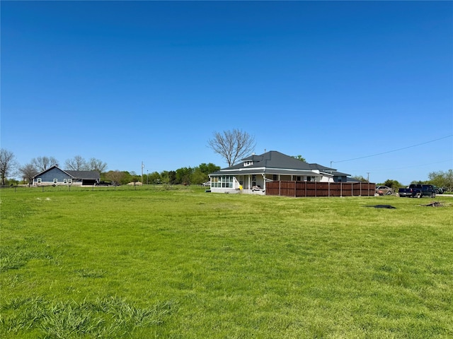 210 E Warren St, Wolfe City, TX 75496 - view of yard featuring a sunroom and fence