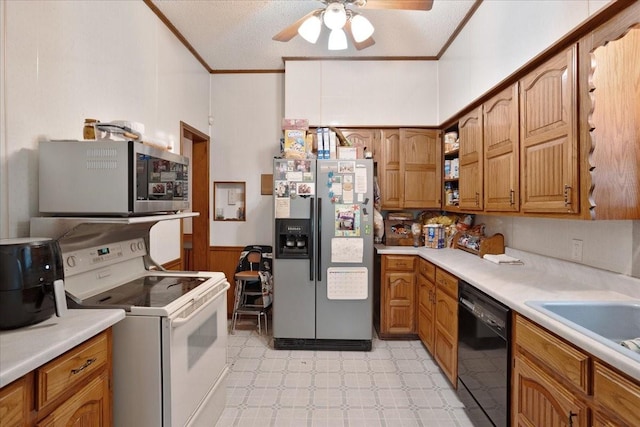 210 E Warren St, Wolfe City, TX 75496 - kitchen featuring brown cabinetry, light floors, ornamental molding, ceiling fan, and appliances with stainless steel finishes