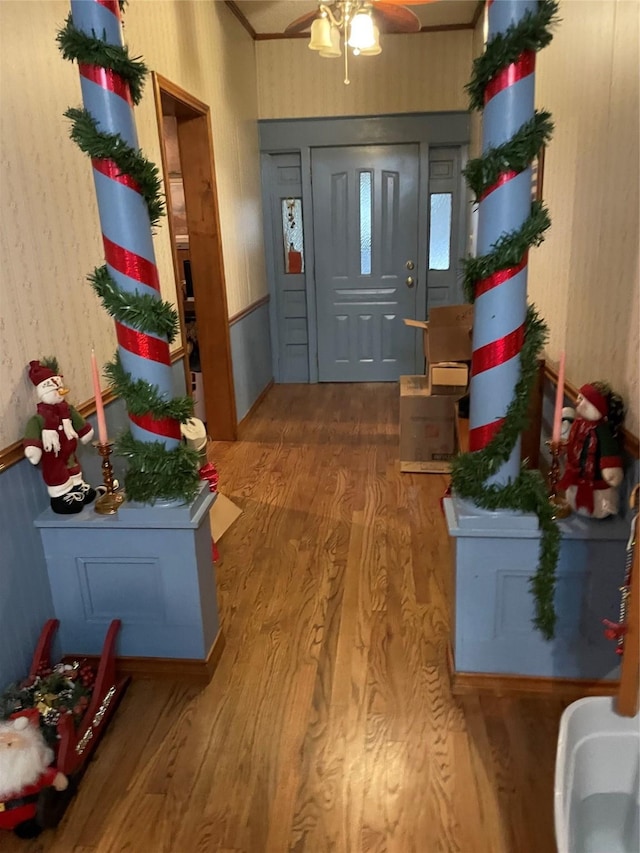 210 E Warren St, Wolfe City, TX 75496 - foyer with wood finished floors, ornamental molding, and a ceiling fan