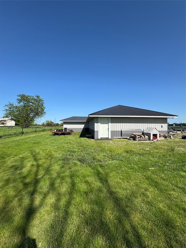 210 E Warren St, Wolfe City, TX 75496 - exterior space with a yard, an outdoor structure, a pole building, and fence