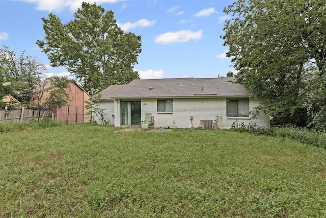 2405 Sweetwood Dr, Fort Worth, TX 76131 - rear view of property with fence, brick siding, a lawn, central AC unit, and a shingled roof
