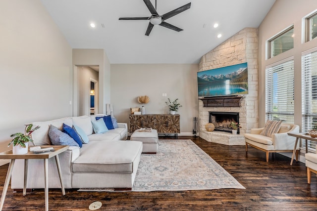 living area with wood finished floors, a ceiling fan, high vaulted ceiling, a stone fireplace, and recessed lighting