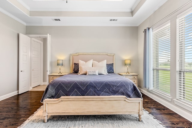 bedroom featuring crown molding, visible vents, and a raised ceiling