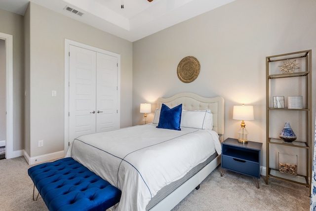 bedroom featuring baseboards, carpet flooring, a closet, and visible vents