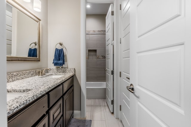 full bathroom featuring double vanity, tub / shower combination, and a sink