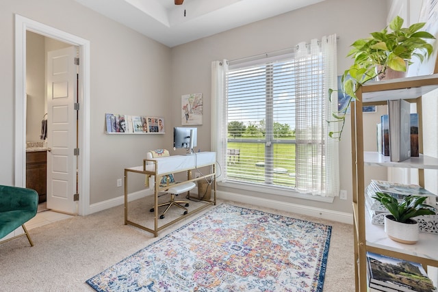 carpeted office with a wealth of natural light, baseboards, and ceiling fan
