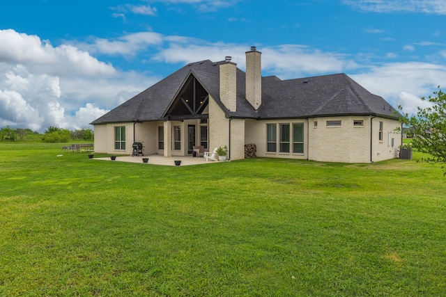 back of property featuring central AC unit, a patio area, a chimney, and a lawn