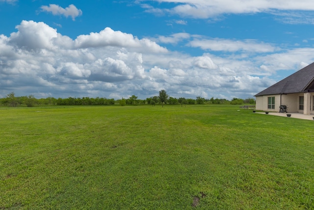 view of yard with a patio and a rural view