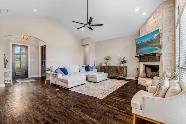 living room featuring visible vents, arched walkways, ceiling fan, lofted ceiling, and dark wood-style floors