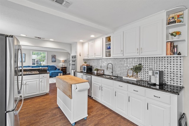 2512 Halloran St, Fort Worth, TX 76107 - kitchen featuring visible vents, a sink, open floor plan, open shelves, and appliances with stainless steel finishes