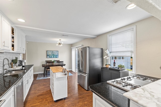 2512 Halloran St, Fort Worth, TX 76107 - kitchen with a sink, white cabinetry, a healthy amount of sunlight, and appliances with stainless steel finishes