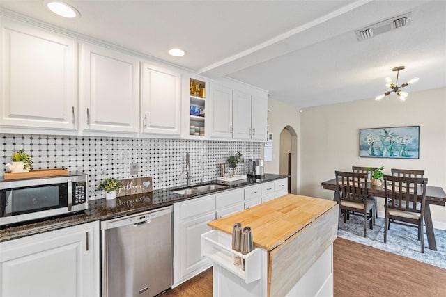 2512 Halloran St, Fort Worth, TX 76107 - kitchen featuring visible vents, a sink, arched walkways, stainless steel appliances, and white cabinets