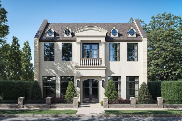 french provincial home featuring a balcony, stucco siding, french doors, and a fenced front yard