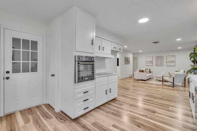 5229 Cockrell Ave, Fort Worth, TX 76133 - kitchen with oven, open floor plan, white cabinetry, light wood-style flooring, and recessed lighting