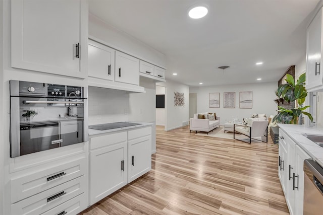 5229 Cockrell Ave, Fort Worth, TX 76133 - kitchen with appliances with stainless steel finishes, white cabinets, light wood-style floors, and recessed lighting