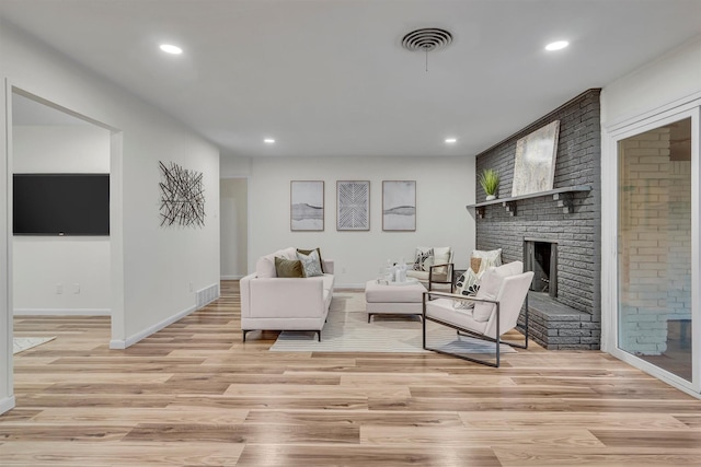 5229 Cockrell Ave, Fort Worth, TX 76133 - living area featuring light wood finished floors, recessed lighting, baseboards, and a brick fireplace