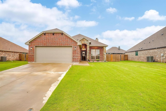 view of front of property featuring fence, a front lawn, and brick siding