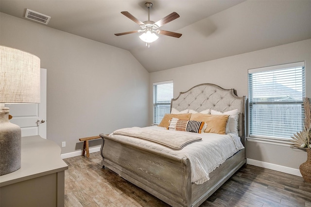 bedroom with lofted ceiling, a ceiling fan, baseboards, visible vents, and wood finished floors