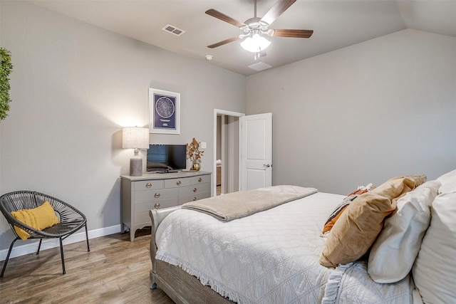 bedroom with visible vents, baseboards, ceiling fan, light wood-style floors, and lofted ceiling