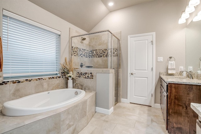 bathroom featuring a stall shower, vanity, lofted ceiling, and a bath